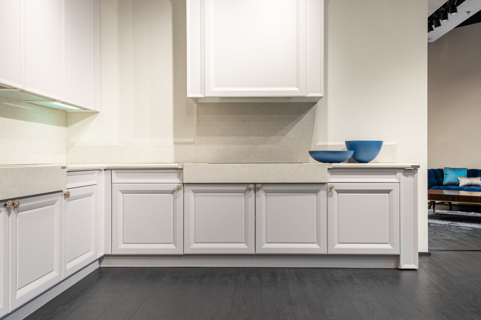 Empty white kitchen units in modern apartment